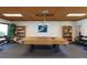 Recreation room featuring a covered pool table, bookshelves, and chairs at 2595 Countryside Blvd # 8205, Clearwater, FL 33761