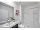 Bright bathroom featuring a shower, neutral-toned walls, granite countertops, and a decorative painting at 32775 Brooks Hawk Ln, Wesley Chapel, FL 33543
