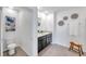 Bathroom showcasing double sinks, tile floors, decorative wall art, and a toilet at 32775 Brooks Hawk Ln, Wesley Chapel, FL 33543
