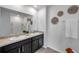 Bathroom featuring double sinks, granite countertops, and decorative wall art at 32775 Brooks Hawk Ln, Wesley Chapel, FL 33543