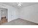 This bedroom features neutral carpet, ceiling fan, and an adjacent bathroom at 32775 Brooks Hawk Ln, Wesley Chapel, FL 33543