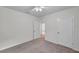 Carpeted bedroom featuring neutral walls, a ceiling fan, and white doors at 32775 Brooks Hawk Ln, Wesley Chapel, FL 33543