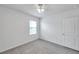 This bedroom features neutral carpet, a ceiling fan, and a window at 32775 Brooks Hawk Ln, Wesley Chapel, FL 33543