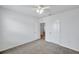 This bedroom boasts neutral carpet, ceiling fan, and adjacent doors at 32775 Brooks Hawk Ln, Wesley Chapel, FL 33543