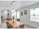 Open dining room features a wooden table, modern light fixture and decor at 32775 Brooks Hawk Ln, Wesley Chapel, FL 33543
