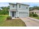 Charming two-story home with a gray exterior, two-car garage, and well-maintained landscaping at 32775 Brooks Hawk Ln, Wesley Chapel, FL 33543