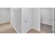 Hallway with wood floors and white walls leading to various rooms at 32775 Brooks Hawk Ln, Wesley Chapel, FL 33543