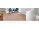 Open hallway features wood floors, two chairs with a side table, and ample space for versatile use at 32775 Brooks Hawk Ln, Wesley Chapel, FL 33543