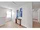 Bright hallway features wood floors, recessed lighting, and stylish decor with blue artwork at 32775 Brooks Hawk Ln, Wesley Chapel, FL 33543