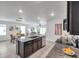 Open concept kitchen with a granite island, stainless appliances, and dining area at 32775 Brooks Hawk Ln, Wesley Chapel, FL 33543