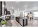 Contemporary kitchen with an island, stainless steel appliances, and an adjacent dining area at 32775 Brooks Hawk Ln, Wesley Chapel, FL 33543
