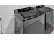 Modern, gray front load washing machine and dryer at 32775 Brooks Hawk Ln, Wesley Chapel, FL 33543