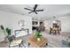 Open-concept living area featuring a modern kitchen, dining space, and stylish decor at 32775 Brooks Hawk Ln, Wesley Chapel, FL 33543