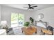 Modern living room with stylish furniture and sliding glass doors to the outdoors at 32775 Brooks Hawk Ln, Wesley Chapel, FL 33543