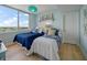 Cozy bedroom featuring two twin beds, bright window with cityscape view, and stylish nautical decor at 331 Cleveland St # 1806, Clearwater, FL 33755