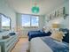 Bright bedroom with two beds, city views from a large window, and a beautifully decorated dresser at 331 Cleveland St # 1806, Clearwater, FL 33755