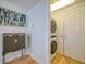 Convenient laundry area with stacked washer and dryer, alongside a stylish cabinet piece at 331 Cleveland St # 1806, Clearwater, FL 33755