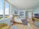 This main bedroom features floor-to-ceiling windows for bay views and is decorated with modern furniture at 331 Cleveland St # 1806, Clearwater, FL 33755