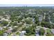 A high-angle aerial showcasing the residential area, greenery, and distant cityscape at 3626 17Th N St, St Petersburg, FL 33713