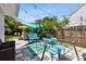 Seating arrangement in backyard with lush landscaping, overhead lights and partial shade at 3626 17Th N St, St Petersburg, FL 33713