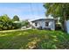 Spacious backyard featuring lush lawn, shade trees, and a hot tub area for outdoor enjoyment at 3626 17Th N St, St Petersburg, FL 33713