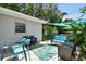Backyard patio showcasing a glass table, outdoor furniture, landscaping and shade sails at 3626 17Th N St, St Petersburg, FL 33713