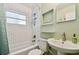 Bathroom with white subway tiles, tub and shower, brushed nickel hardware and pedestal sink at 3626 17Th N St, St Petersburg, FL 33713