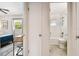 View from bedroom to white tile bathroom with tub, toilet, sink and window at 3626 17Th N St, St Petersburg, FL 33713