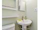 Close-up of bathroom with pedestal sink, shelves, mirror and light green paint at 3626 17Th N St, St Petersburg, FL 33713