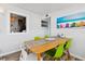 Bright dining area with beach-themed artwork and seating for five at 3626 17Th N St, St Petersburg, FL 33713