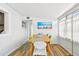 Dining area with a wooden table, colorful beach art, and plenty of natural light at 3626 17Th N St, St Petersburg, FL 33713