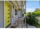 Bright yellow front door with modern details and brick walkway and nearby plants at 3626 17Th N St, St Petersburg, FL 33713