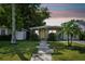 Charming single-story home with a stepping stone walkway to a bright yellow front door and a well-maintained front lawn at 3626 17Th N St, St Petersburg, FL 33713