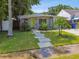 Charming single-story home featuring a well-manicured front yard, stepping stone path, and bright, inviting yellow front door at 3626 17Th N St, St Petersburg, FL 33713