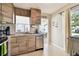 Well-appointed kitchen with stainless steel appliances and stylish cabinets, next to a brightly lit living area at 3626 17Th N St, St Petersburg, FL 33713