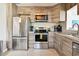 Modern kitchen showcasing stainless steel appliances, natural wood cabinets, and efficient layout at 3626 17Th N St, St Petersburg, FL 33713
