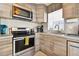 Modern kitchen featuring stainless steel appliances, wood cabinets, and an adjacent coffee station at 3626 17Th N St, St Petersburg, FL 33713