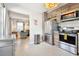 Contemporary kitchen with stainless steel appliances and wood cabinets adjacent to the comfortable living area at 3626 17Th N St, St Petersburg, FL 33713