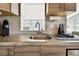Close-up of kitchen sink with stylish fixtures, concrete countertop, and a cozy coffee station at 3626 17Th N St, St Petersburg, FL 33713