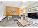 Comfortable living room with sectional sofa, wood accent wall, and view of the bedroom at 3626 17Th N St, St Petersburg, FL 33713