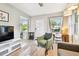 Cozy living room featuring stylish decor and comfortable seating, with a work space by the window at 3626 17Th N St, St Petersburg, FL 33713