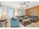 Cozy living room featuring a comfortable sectional sofa and wood accent wall at 3626 17Th N St, St Petersburg, FL 33713
