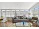Bright sunroom featuring a comfortable couch, glass table, and lots of windows for natural light at 3626 17Th N St, St Petersburg, FL 33713