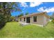 Spacious backyard with a manicured lawn, perfect for outdoor activities and relaxation at 3803 E Curtis St, Tampa, FL 33610