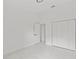 Bedroom featuring white trim, white marble flooring, a closet, and an open door at 3803 E Curtis St, Tampa, FL 33610