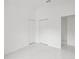 Bedroom with white walls, marble flooring, and double closets with a door to the hall at 3803 E Curtis St, Tampa, FL 33610