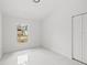 Bedroom featuring white trim, marble flooring, a window, and a closet at 3803 E Curtis St, Tampa, FL 33610