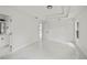 Bright bedroom featuring white walls, tray ceiling, and glossy white marble floors at 3803 E Curtis St, Tampa, FL 33610