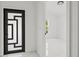 Entryway featuring a modern black and white door and white marble floors at 3803 E Curtis St, Tampa, FL 33610