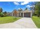 Beautifully landscaped home featuring a concrete driveway and a neatly maintained front yard at 3803 E Curtis St, Tampa, FL 33610